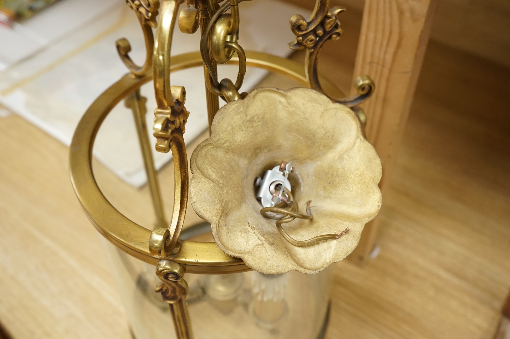 A cylindrical brass hanging hall lantern, 86cm high overall